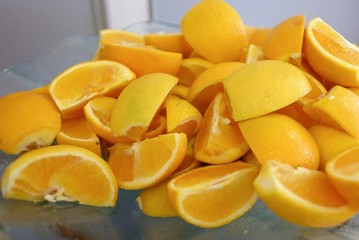 A pile of fresh orange slice in a bowl on a dinning table