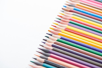Selective focus of sharpened colored pencils on white