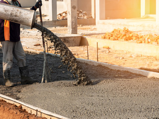 mixed concrete pouring at construction site on the road