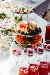 buffet table with wine and juice, fruits and sweets, snacks and mint ice