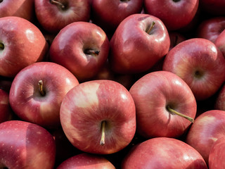 Ripe organic red apples on the farmers market. Close-up apple background. Healthy vegan food.