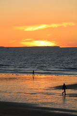 Sunset and Kitesurfers on the beach in Saint Malo,  Brittany, France