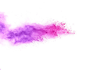 Freeze motion of purple color powder exploding on white background.