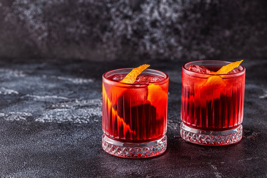 Negroni cocktail with orange peel and ice.