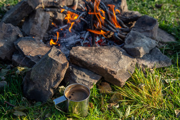 tourist mug in the mountains with coffee. Holidays in the Carpathian mountains.