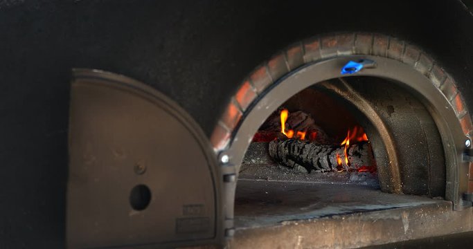 Fire, firewood and flame in Swedish oven ready for food baking and cooking, 4K