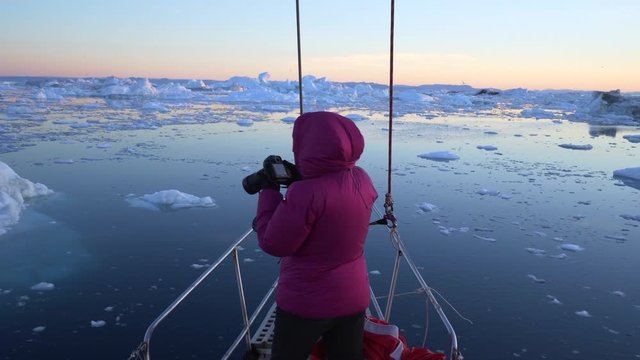 Man photographing beautiful view of icebergs at Disko Bay