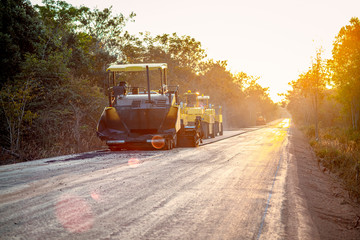 Road works in the city. Working on special equipment cut off the old asphalt on a Sunny summer day