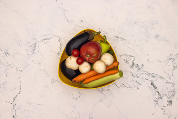 Fresh vegetables in pot on kitchen table 