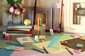 Books, flowers, apple, stationery, frames and colored paper on the table, education, back to school, summer, autumn