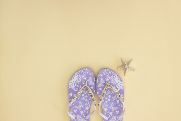 Summer and beach accessories on yellow background 