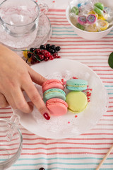 French colorful macaroons. Colorful pastel macaroons on white background. Pink and blue macaroons. Still life in pink and white