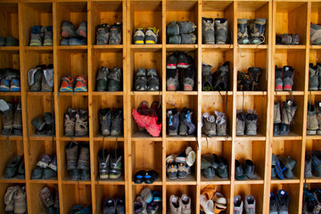 Collection of hiking boots in a mountain cabin in the Pyrenees