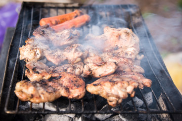Grilled chicken breast with fire and smoke .