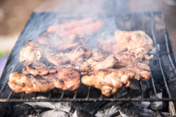 Grilled chicken breast with fire and smoke .
