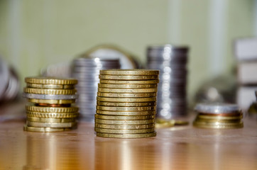 gold coins on a wooden background, close-up.