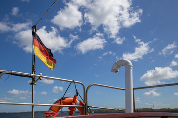 Fototapeta na wymiar Deutsche Fahne und Rettungsring mit blauem Himmel