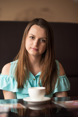 Portrait of a beautiful girl resting in a cafe.