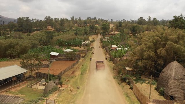 China in Africa - aerial view of Chinese construction truck driving through mountain village near Arba Minch in South Ethiopia