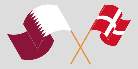 Obraz premium Crossed and waving flags of Denmark and Qatar