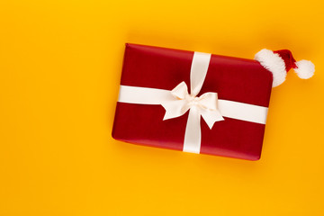 Christmas, holiday present box on red background.