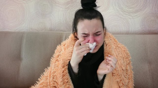 Sick woman sneezes and coughs. Viral diseases in the cold period.