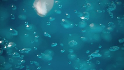 Bubbles rising to the surface. Air bubbles in water in sea (underwater shot), good for backgrounds. Slow motion.