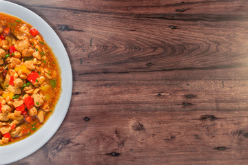 Tasty chess chicken. Chinese food. Wooden background