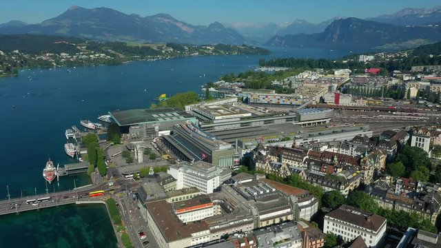flight over luzern city center riverside train station sunset time aerial panorama 4k switzerland