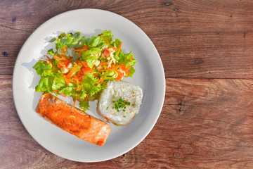 Tasty Salmon with rice and salad as a side