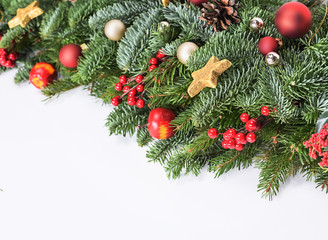 Christmas decorative background border with red bauble decorations, holly berries, spruce and pine cones
