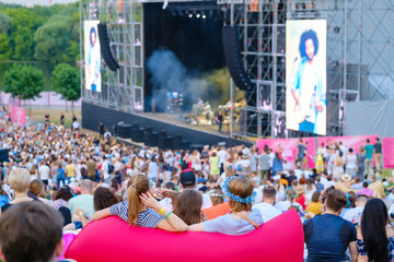Women are watching concert at open air music festival
