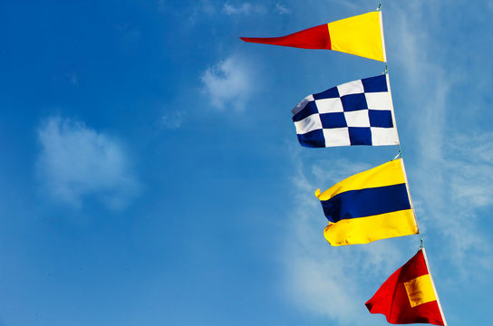 Marine signal flags on a blue sky background.