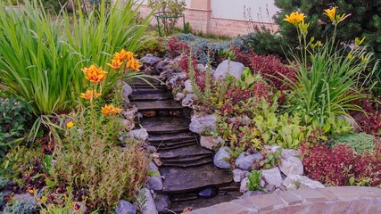 Gorgeous view of exterior of a private garden. Landscape design called Alpine slide. Decorative...