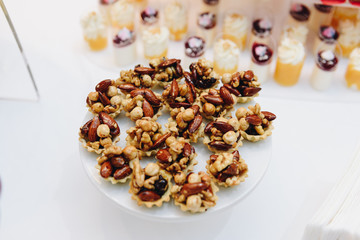 A plate of nut cakes on while table close-up