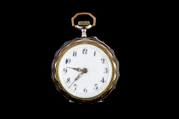 Old vintage pocket watch on black background. Silver, gold, metal. Fashion. Pocket watch antiques
