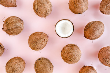 Pattern, texture with coconuts on pink background. Tropical abstract background. Flat lay, top view.