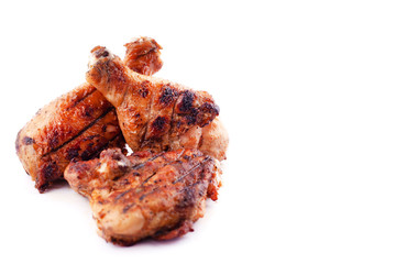 grilled chicken legs with crust on a white background.