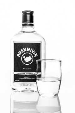 ROCKAWAY, NEW JERSEY - SEPTEMBER 18, 2018: Bottle of Brennivin with shot glass. Brennivin is a clear, unsweetened schnapps that is considered to be Iceland's signature distilled beverage