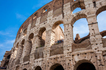Fototapeta premium ROME, ITALY - APRIL, 2018: Tourists visiting the famous Colosseum or Coliseum also known as the Flavian Amphitheatre in the centre of the city of Rome