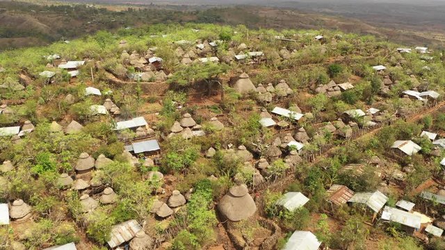 Tilting aerial footage of beautiful traditional homes (made with mud and straw) in Konso, Ethiopia