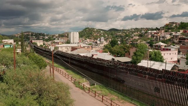 Aerial Perspective Elevating up over the Border Wall at Nogales Arizona