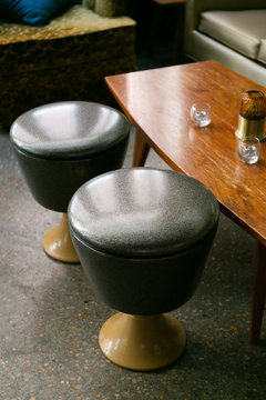 Two Black And Yellow Stools In Front Of Coffee Table, Mid Century Modern Style, Restaurant Lounge And Bar Furniture