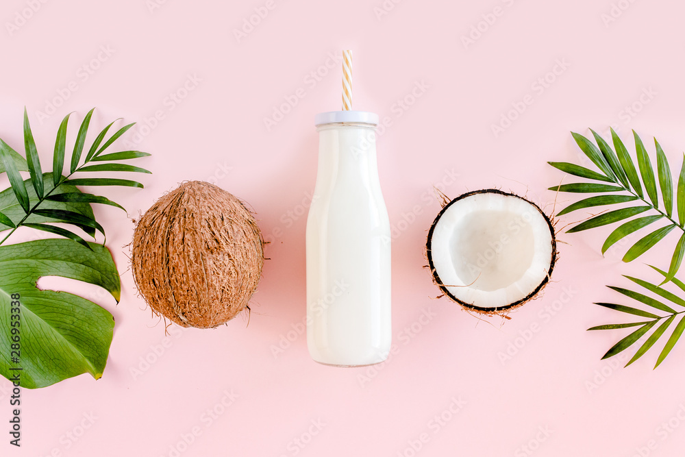 Poster Pattern with coconuts, coconut milk, cocktail on pink background. Tropical abstract background. Flat lay, top view.