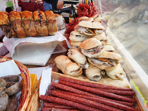 Italian flavors with the stall displaying typical products such as roast pork, sausages and sandwiches, an assorted street food