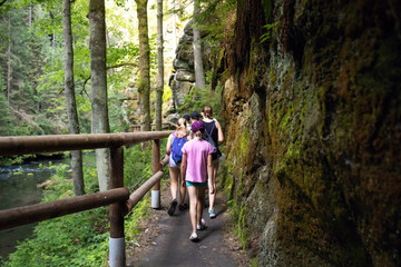 Youth on the tourist route.Footbridge in the tourist route among rocks and trees.Czech Switzerland National Park. A national park famous for its sandstone formations, wild valleys and frozen waterfall