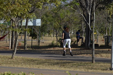 A beautiful view of people walking with rollerblades in Brasilia park, Brazil
