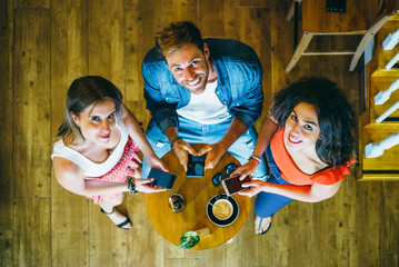 Three young friends having fun in restaurant