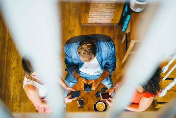Three young friends having fun in restaurant