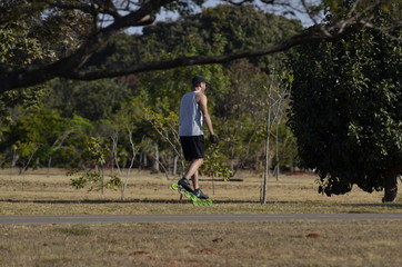 A beautiful view of people walking with rollerblades in Brasilia park, Brazil